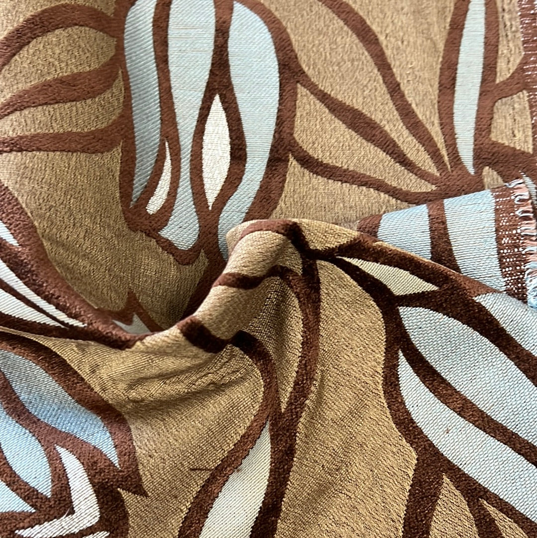 Brown and blue patterned upholstery fabric with an abstract leaf design.
