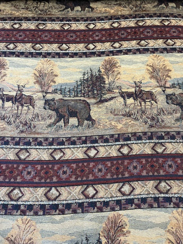 Cabin Life Bear tapestry fabric: woodland scene with bear, deer, and geometric border.