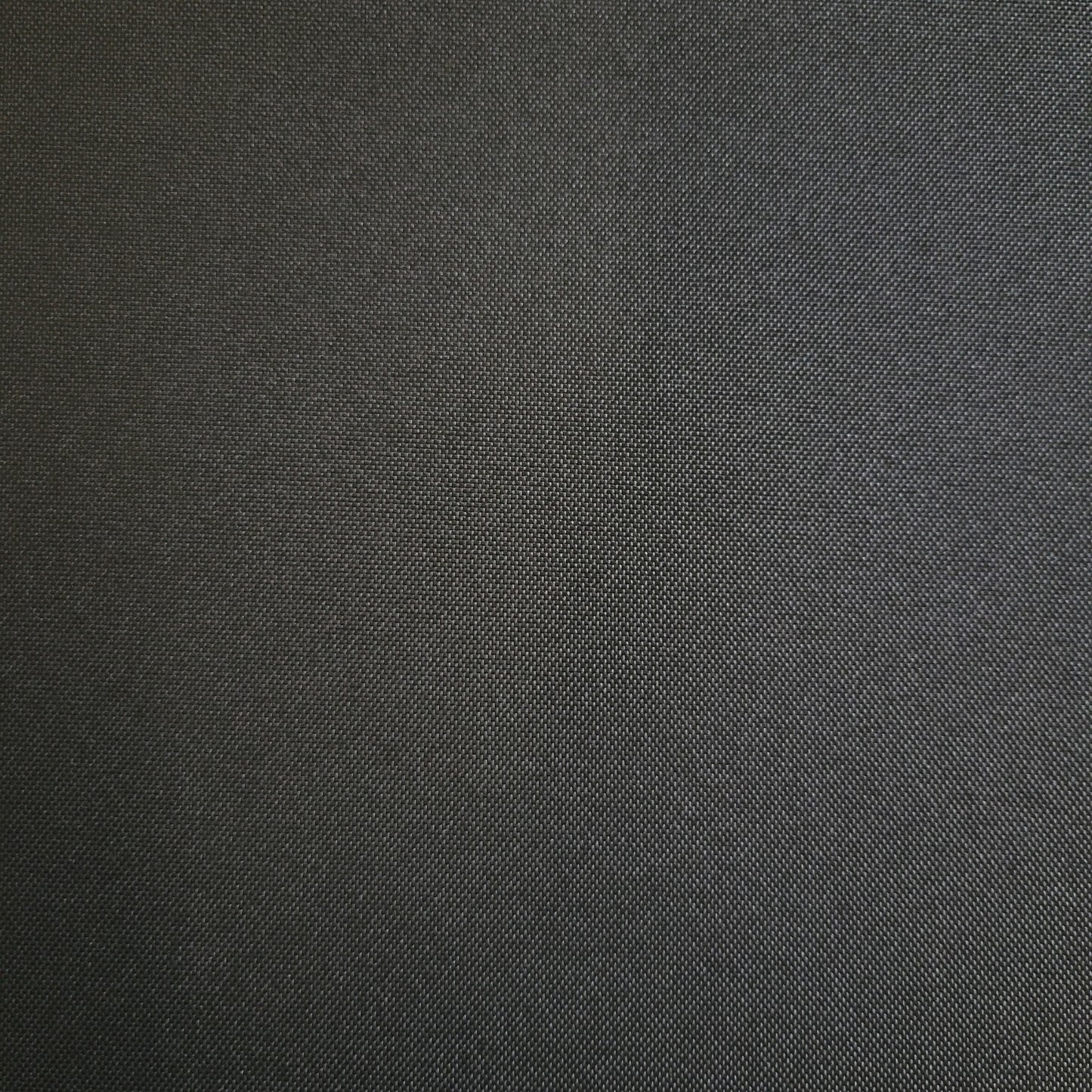 Carter Black Onyx Ford ring #1852: close-up of dark gray textured fabric.