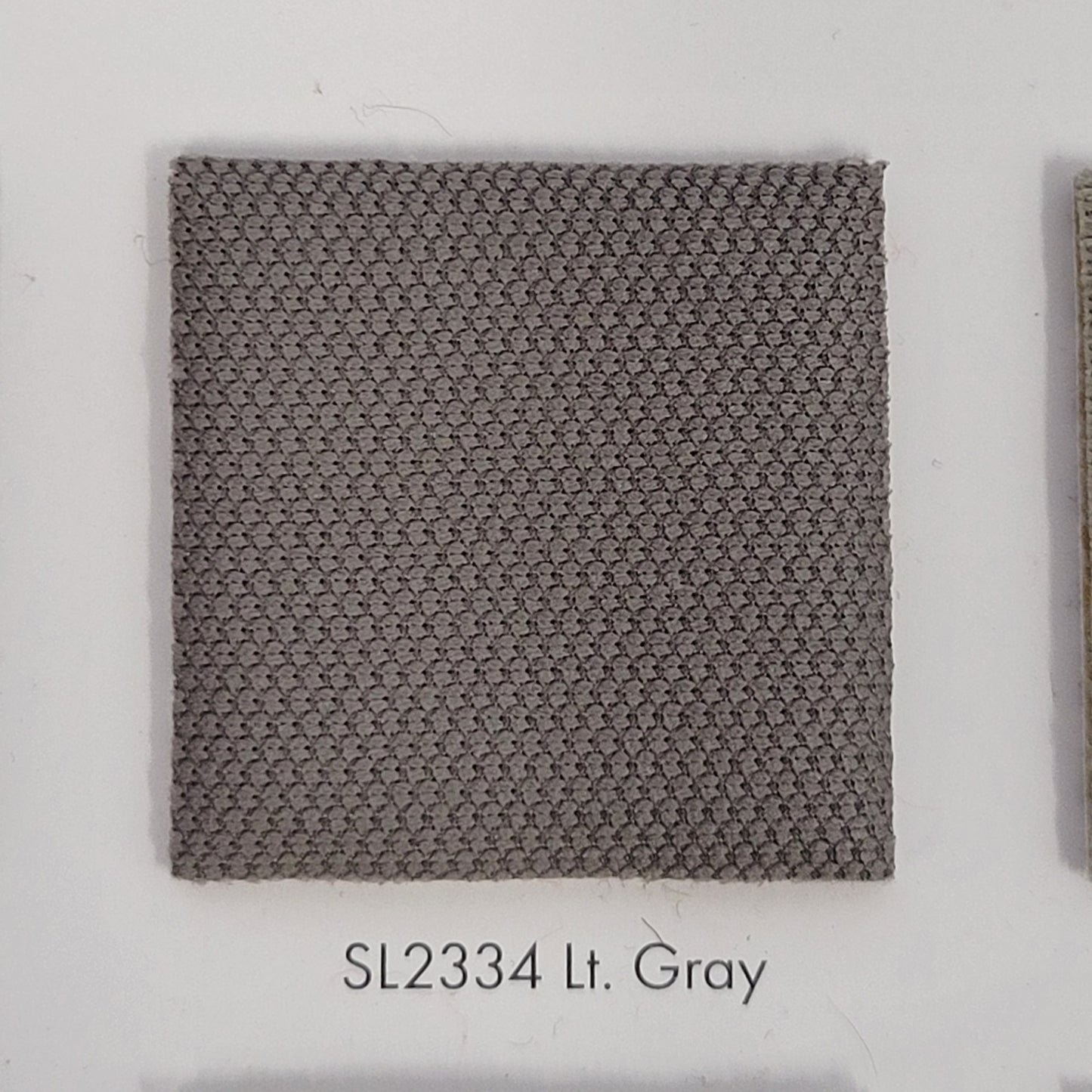 SL2334 Lt. Gray fabric swatch: textured light gray upholstery material sample.
