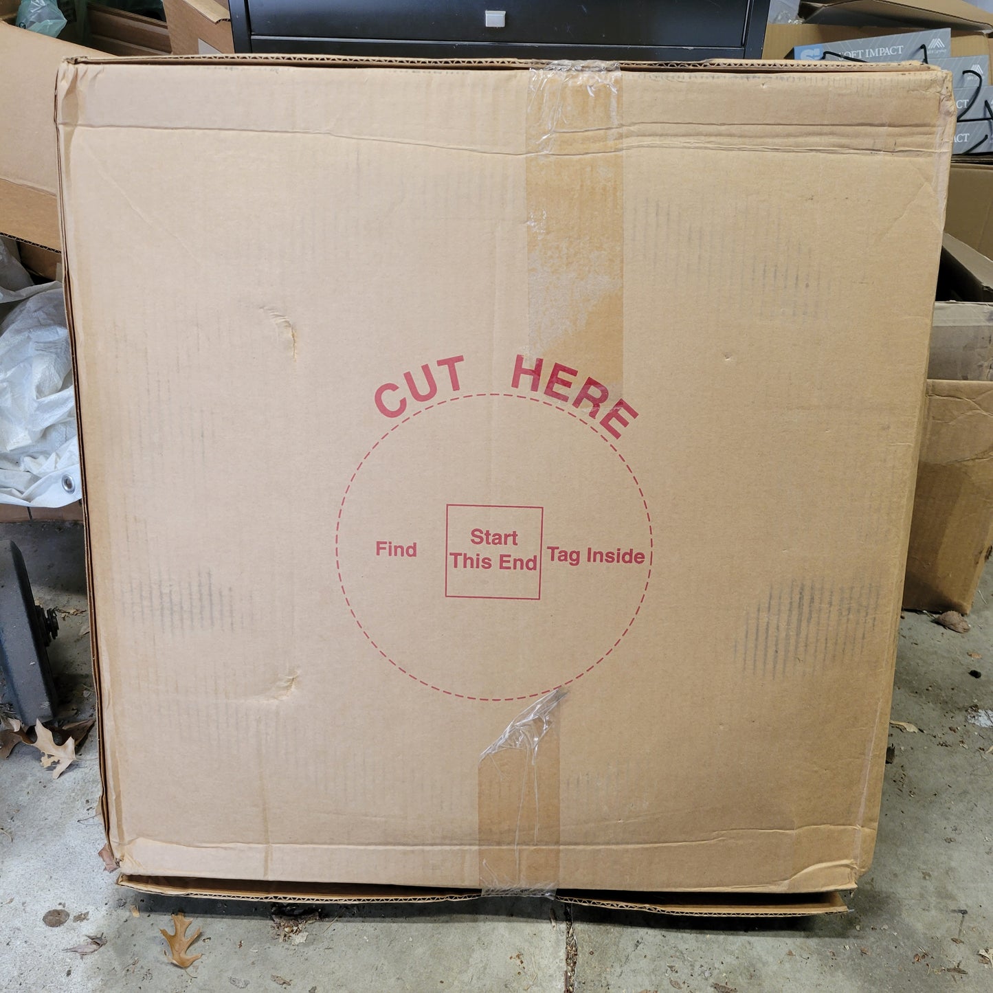 Large cardboard box with "Cut Here" instructions and "Start This End" marking.