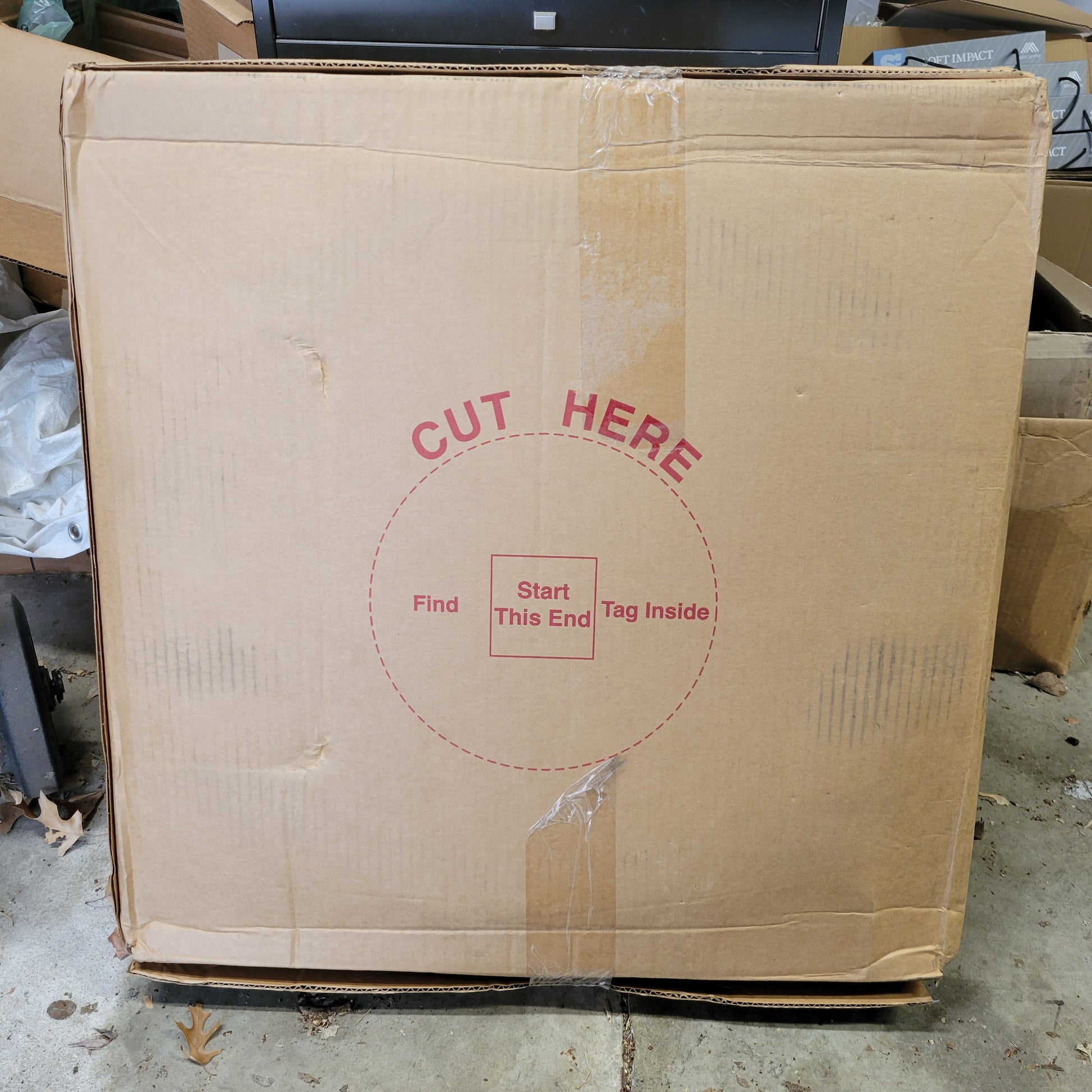 Large cardboard box with "Cut Here" instructions and "Start This End" marking.