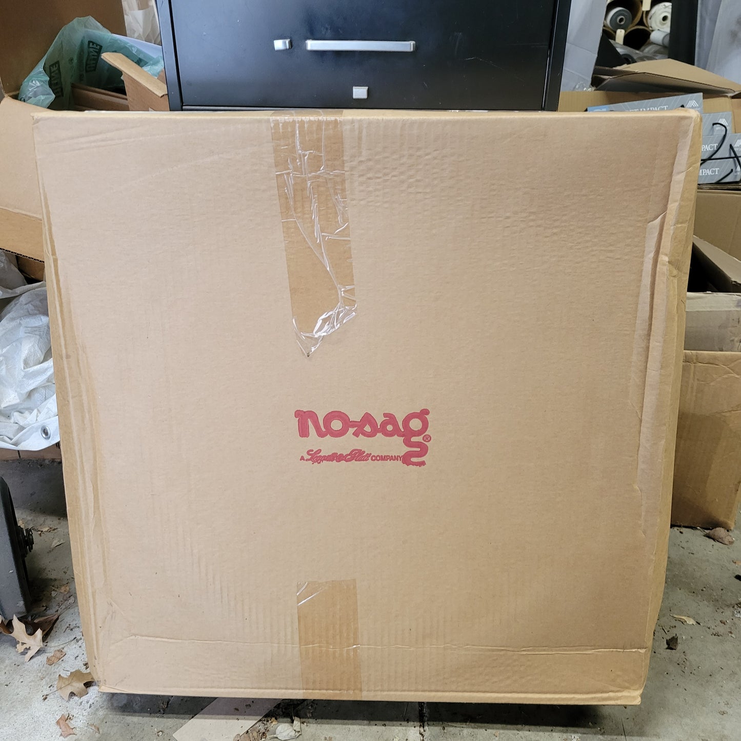 Large cardboard box of wire stakes, showing a company logo.