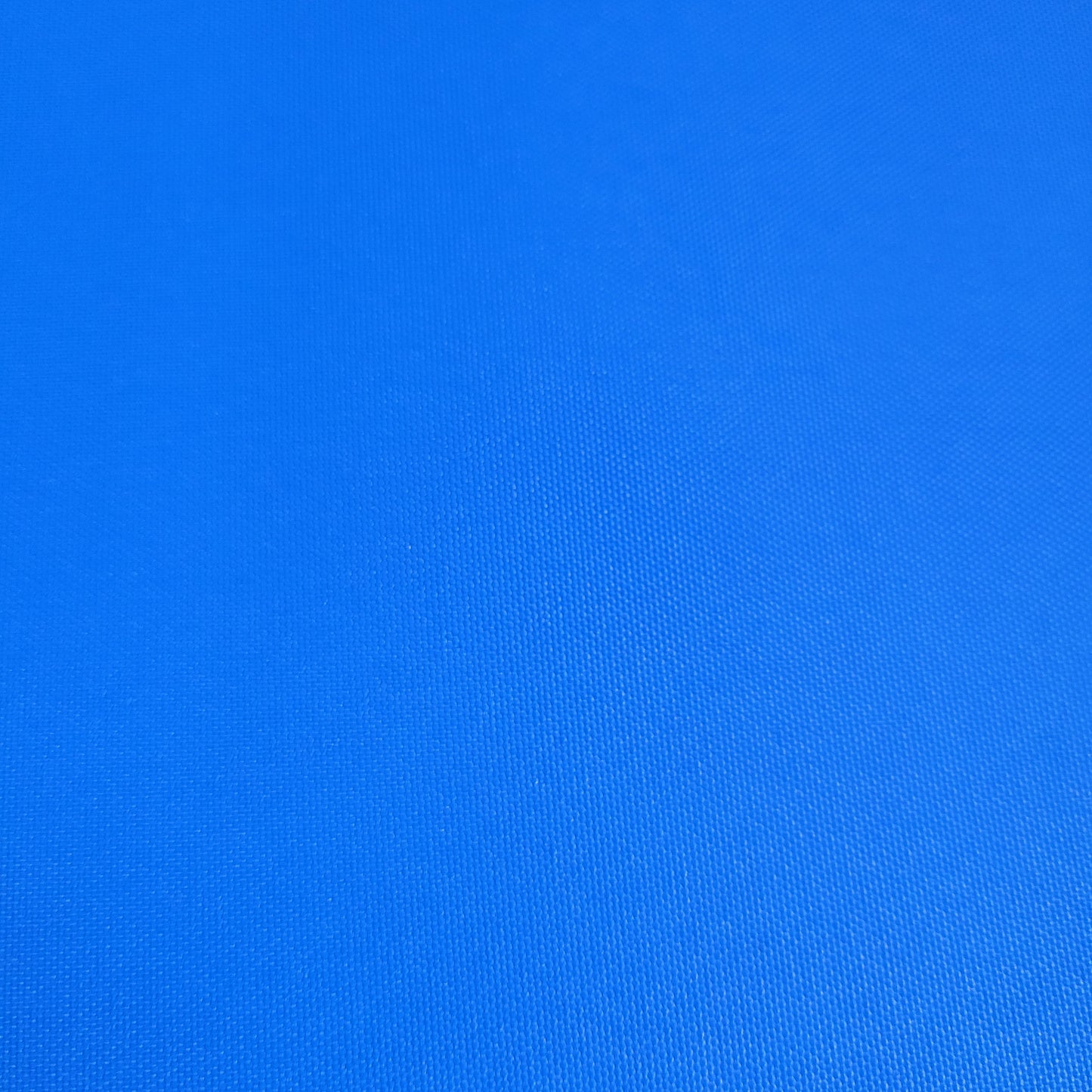 Close-up view of vibrant blue outdoor fabric, showing textured weave.