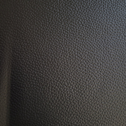 Close-up of dark gray pebbled leather hide.
