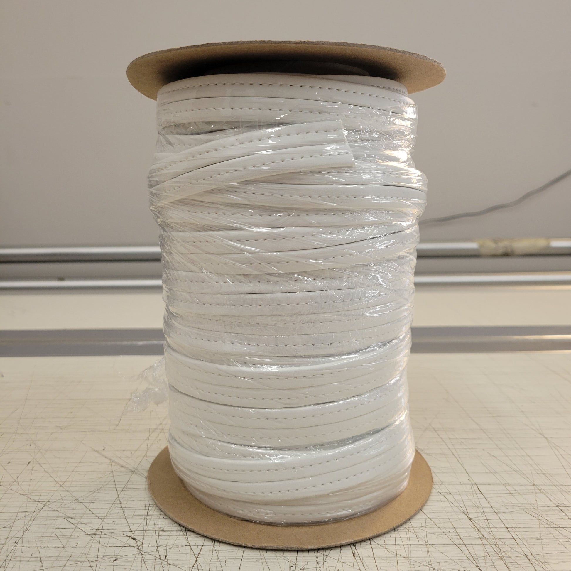 White Hidem Welt 25yd roll of white leather cord, perfect for DIY projects.