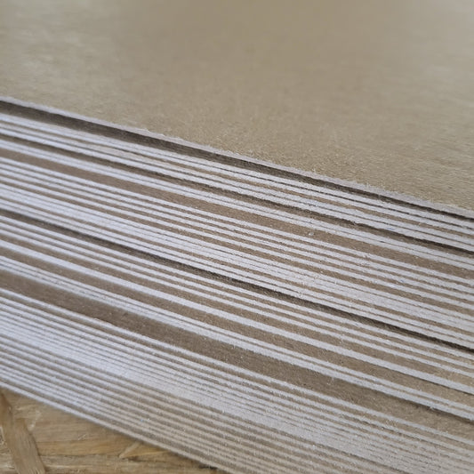 Stack of light brown visor boards, showing layered construction.