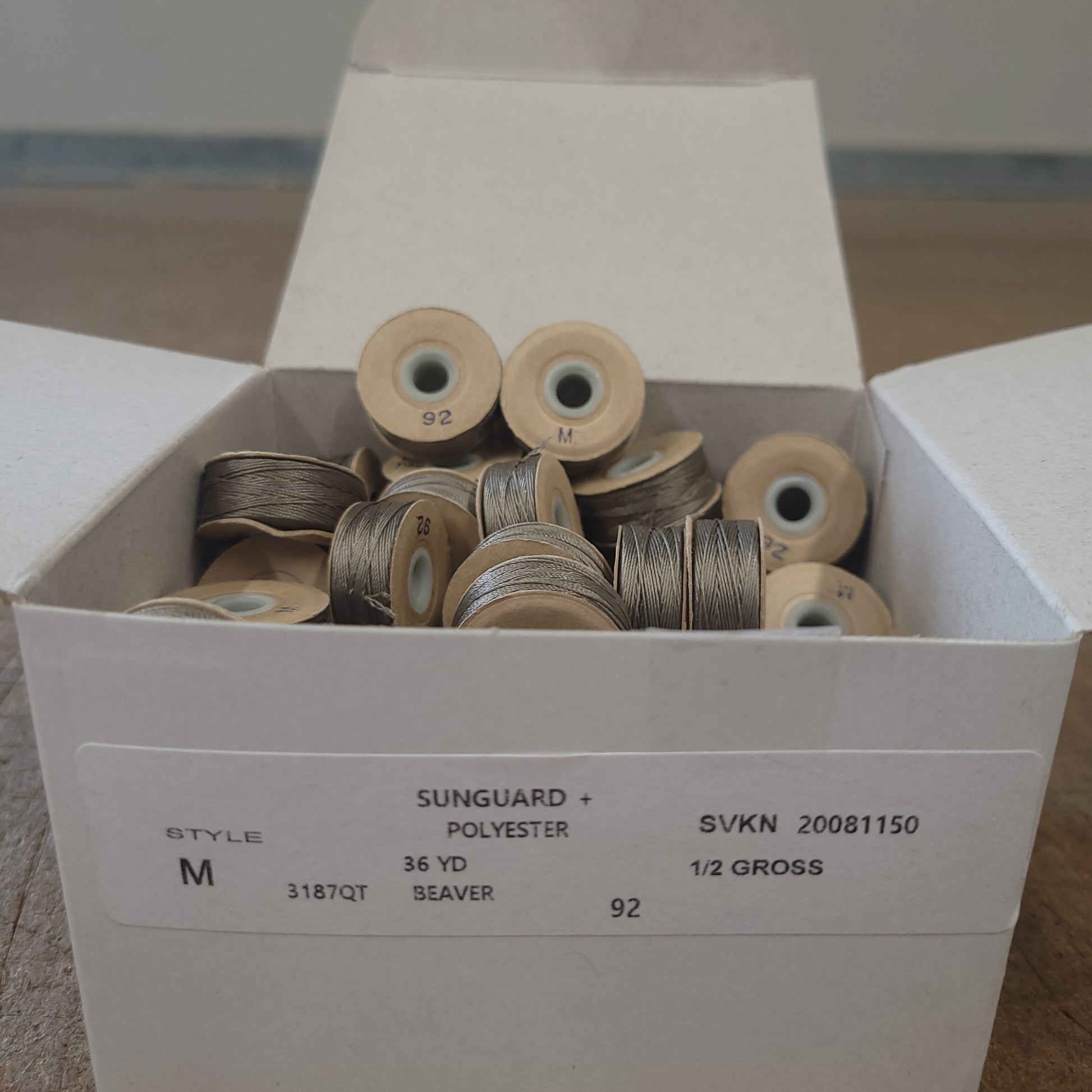 Sunguard 92M Beaver Bobbins 229Q: 1/2 gross, size M, 36 yd polyester thread spools in a box.