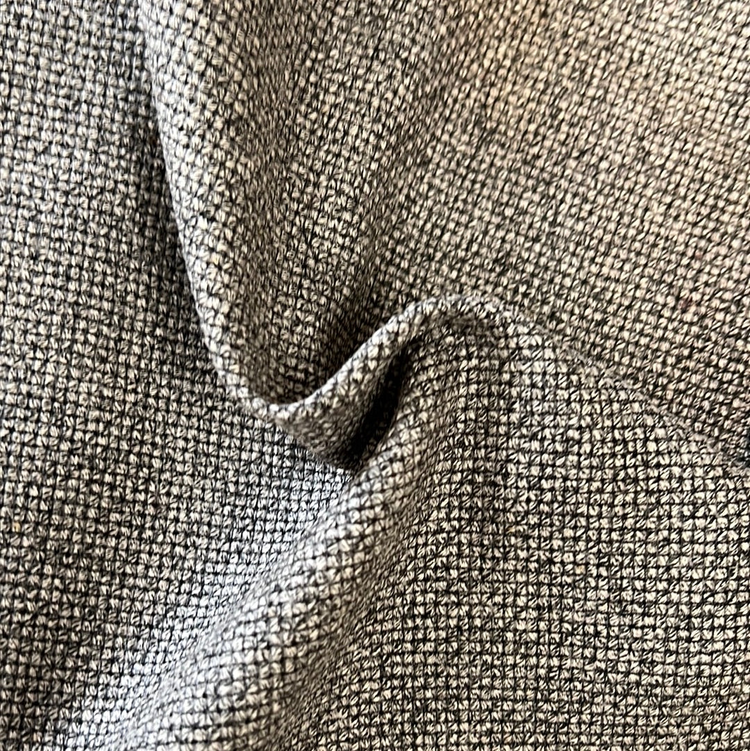 Close-up of charcoal gray textured fabric, showing subtle weave detail.