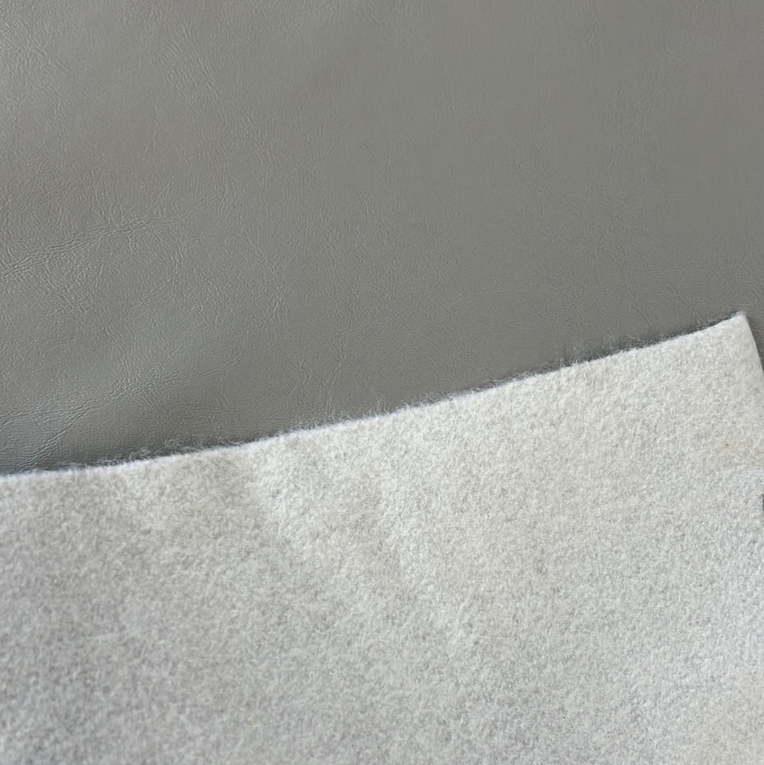 Gray marine vinyl sample showcasing textured surface and off-white backing.
