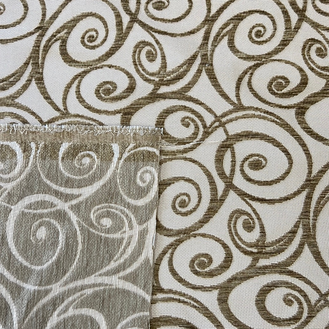 Beige upholstery fabric sample showcasing swirling Art Nouveau pattern.