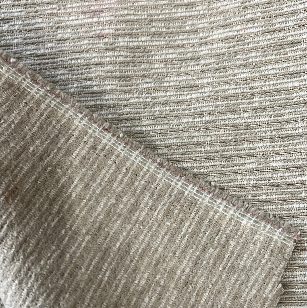 Close-up of beige textured fabric swatch with subtle linear pattern.