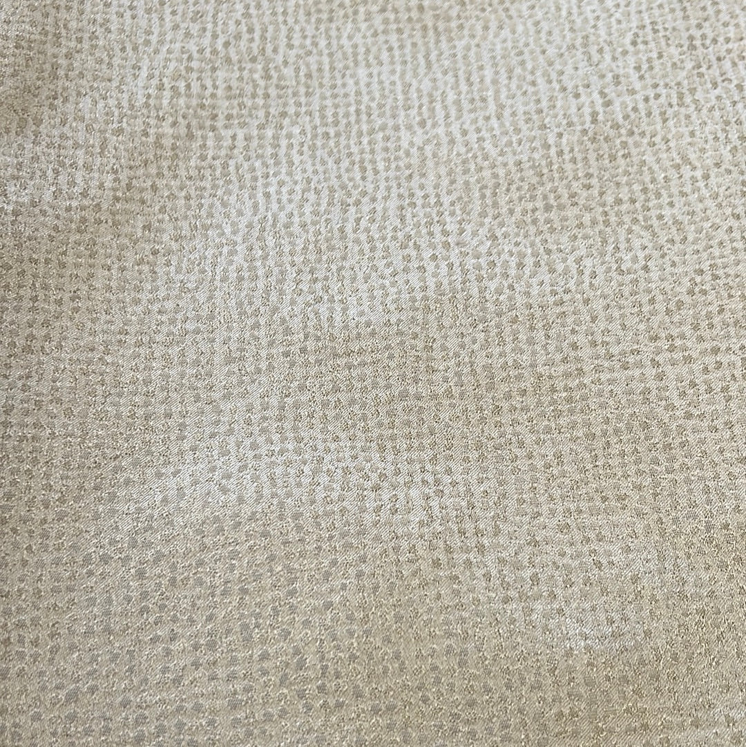 Close-up of sage-colored fabric with subtle textured pattern.