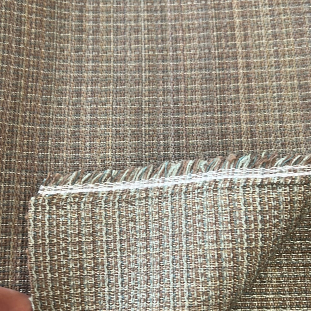 Brown textured fabric swatch with subtle grid pattern, showcasing a woven detail.