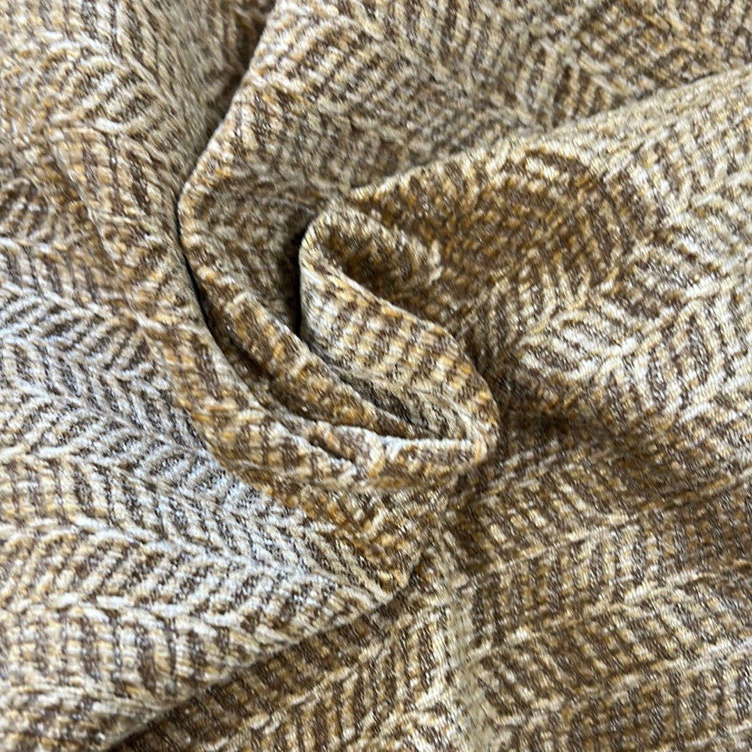 Close-up of textured beige and brown fabric with a subtle herringbone pattern.