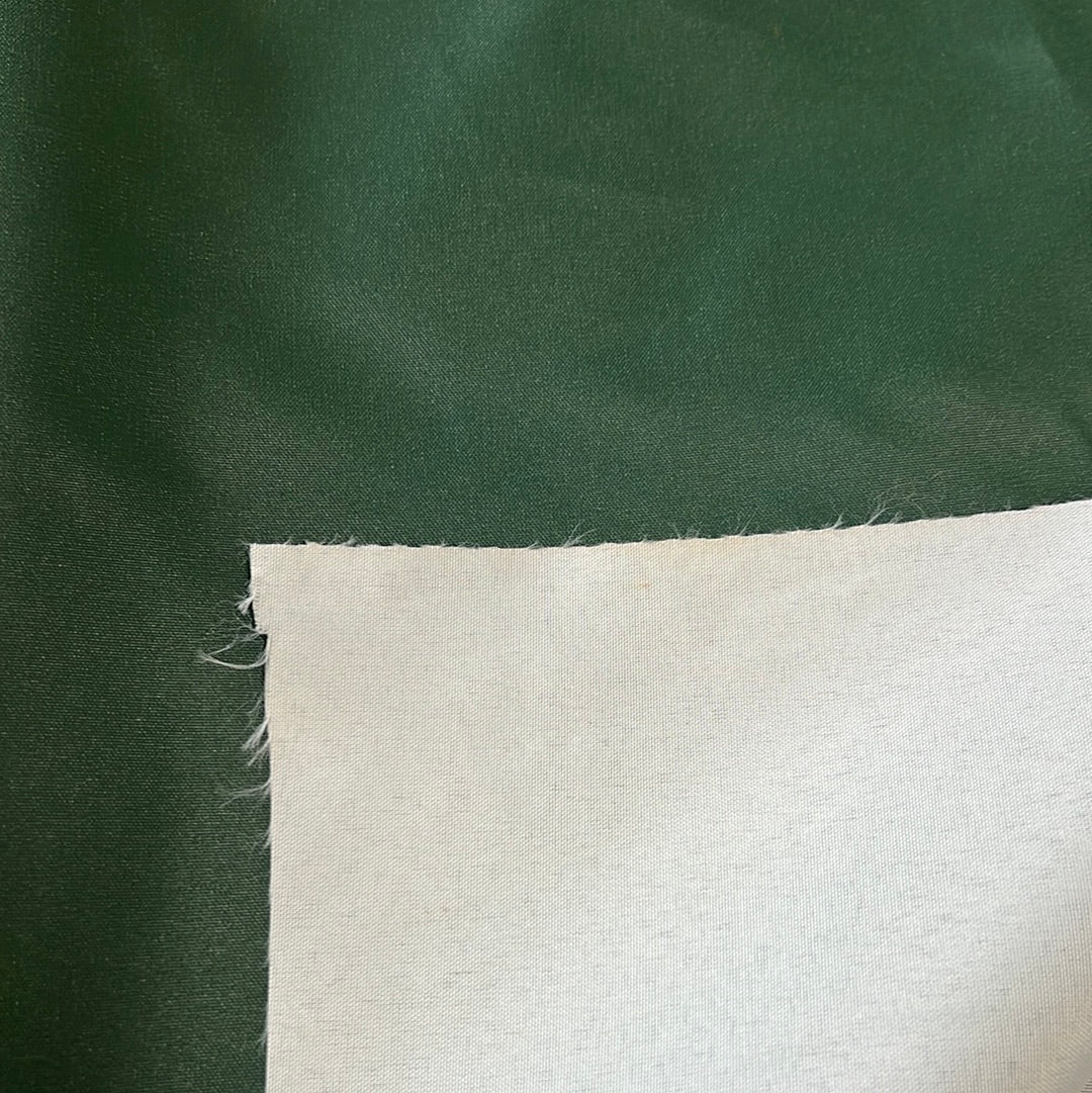 1916 Green solution-dyed polyester fabric swatch: rich dark green, showing texture and off-white backing.