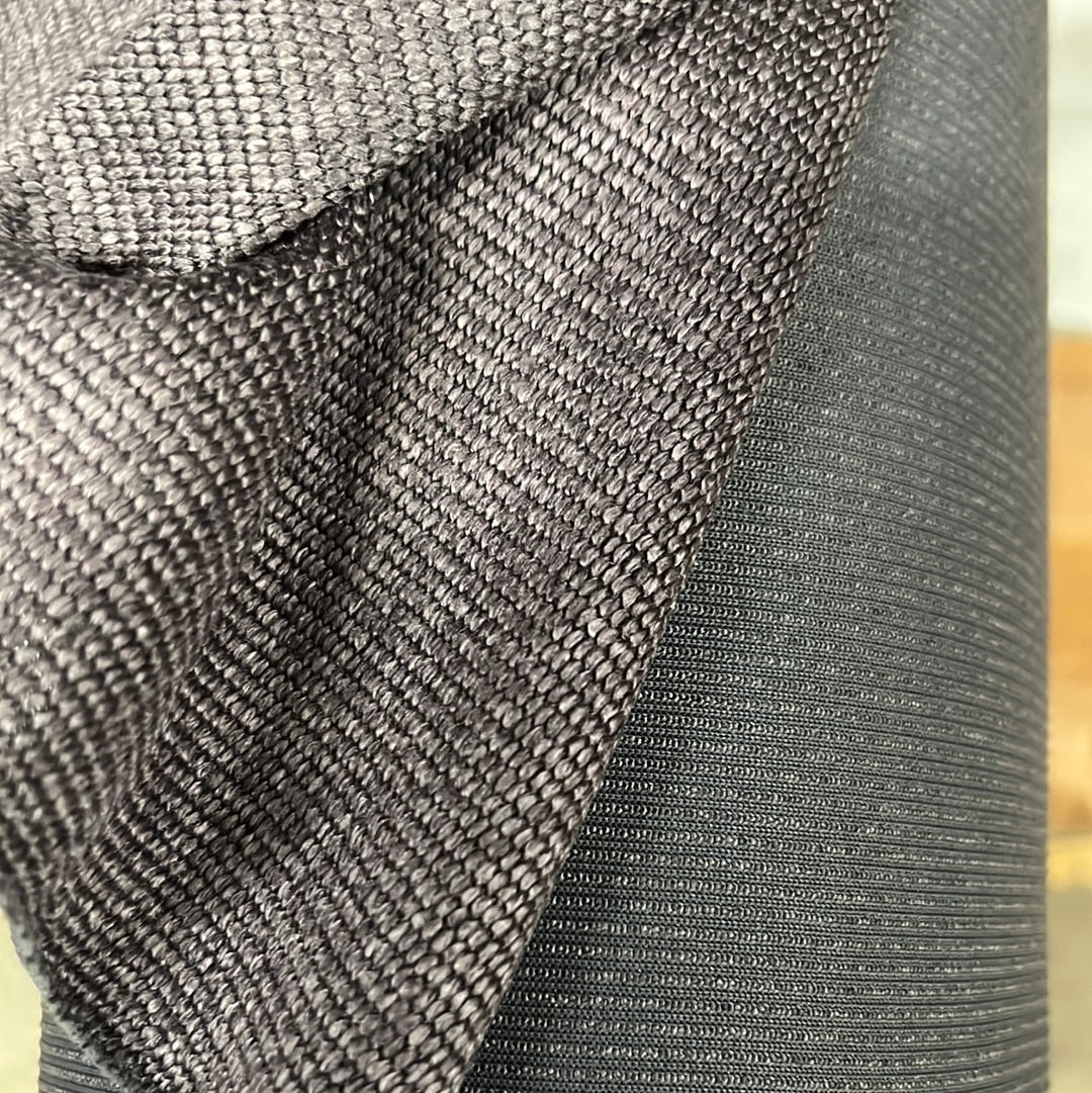 Mordura Steel Gray fabric: Textured steel gray upholstery fabric shown next to its black backing.