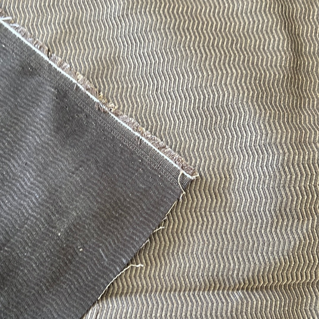 Brown and beige chevron fabric swatch, showing texture and weave detail.