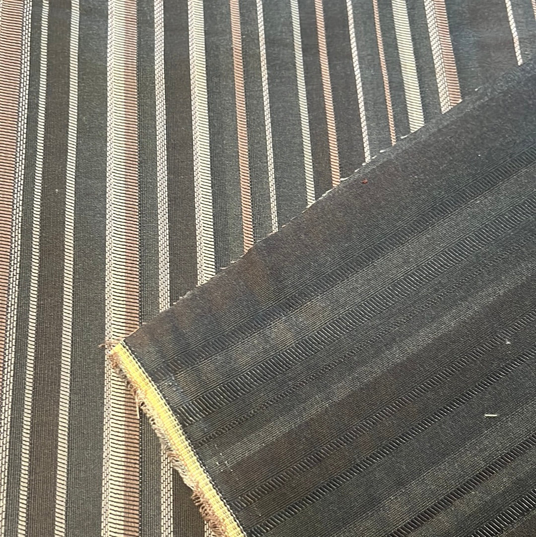 Dark gray and beige striped upholstery fabric sample, close-up view.