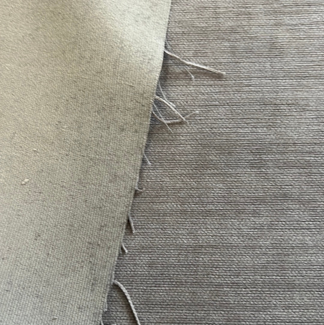 Close-up view of two fabric swatches, showcasing texture and color variations.