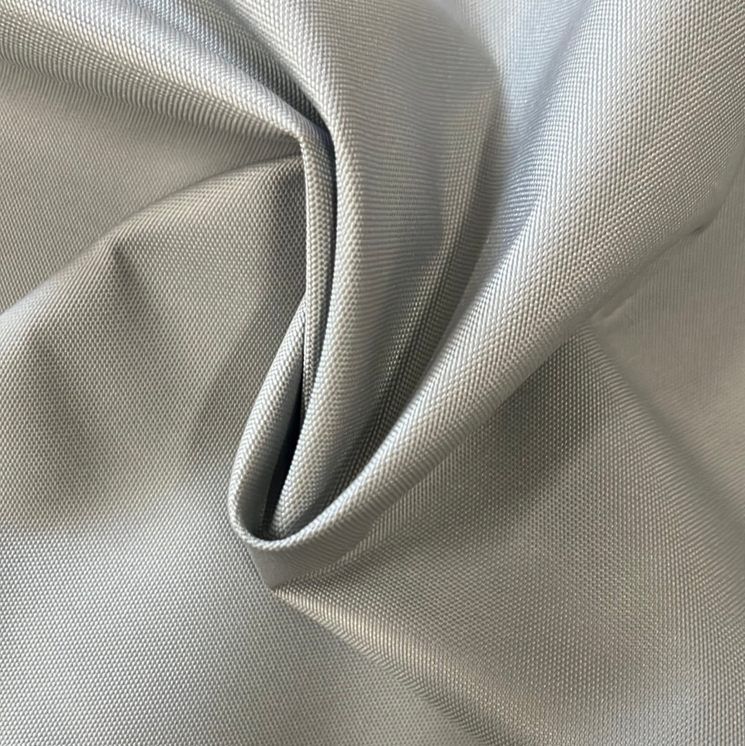 Draped gray polyester fabric, solution-dyed for colorfastness, showcasing its texture and 60-inch width.