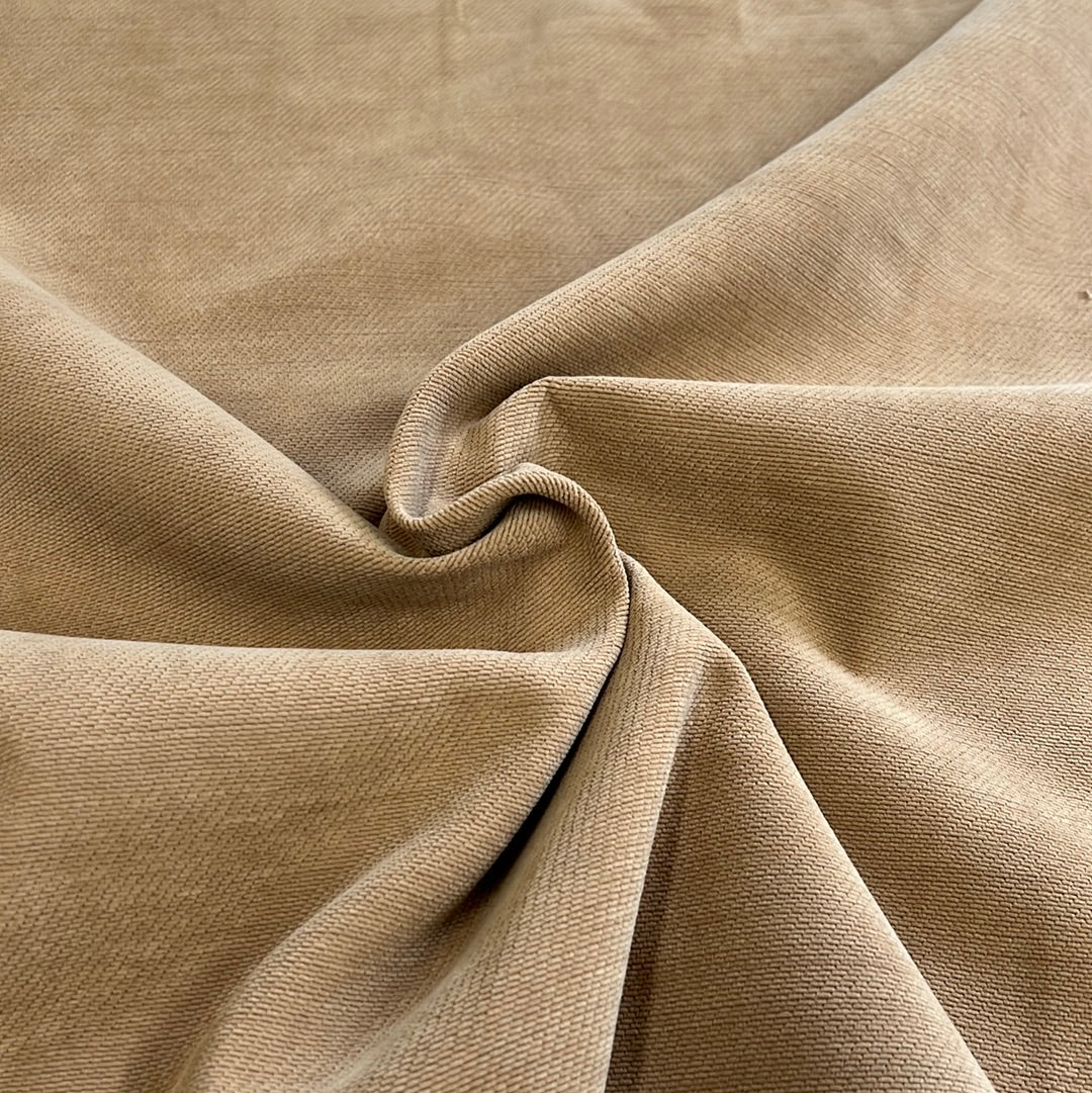 Close-up of taupe corduroy fabric, showing texture and drape.