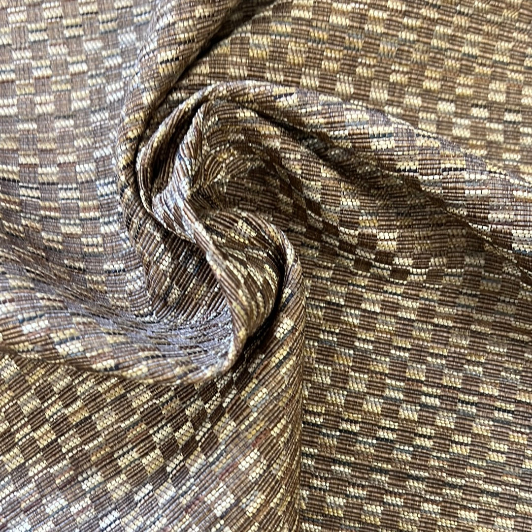 Brown and beige textured fabric swatch, showing a subtle checkered pattern.