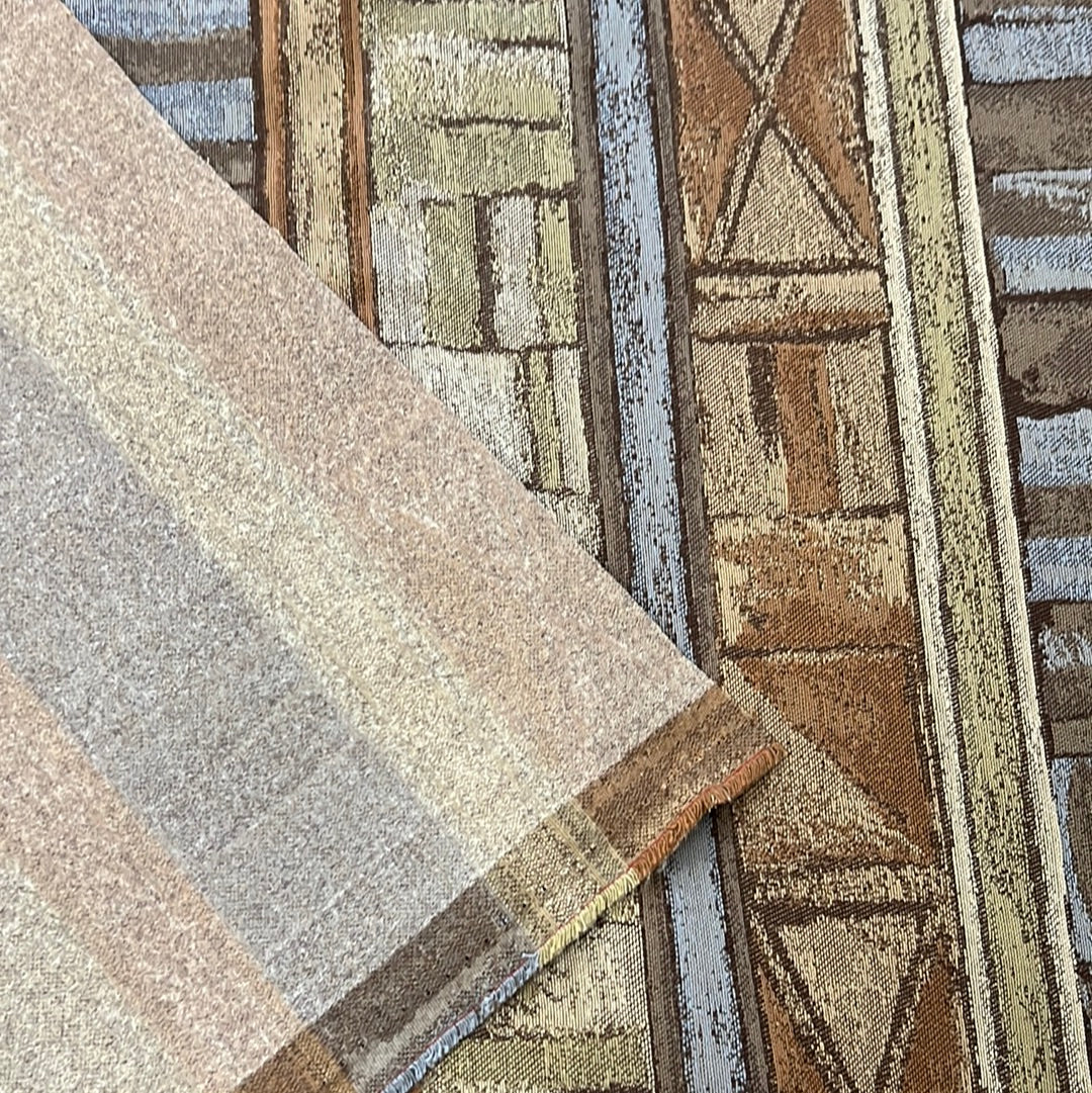 Earthy-toned upholstery fabric swatch showcasing geometric and striped patterns.