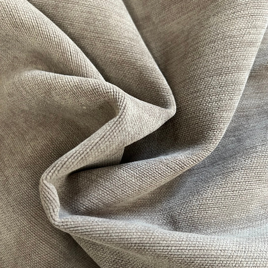 Close-up of taupe-colored upholstery fabric with a subtle ribbed texture.