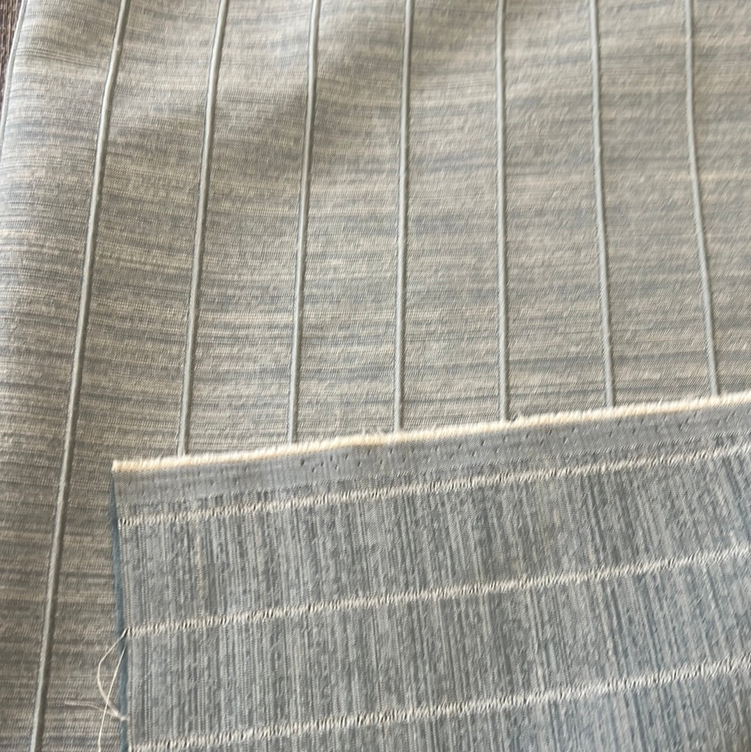 Grey ribbed fabric swatches showcasing texture and subtle color variations.