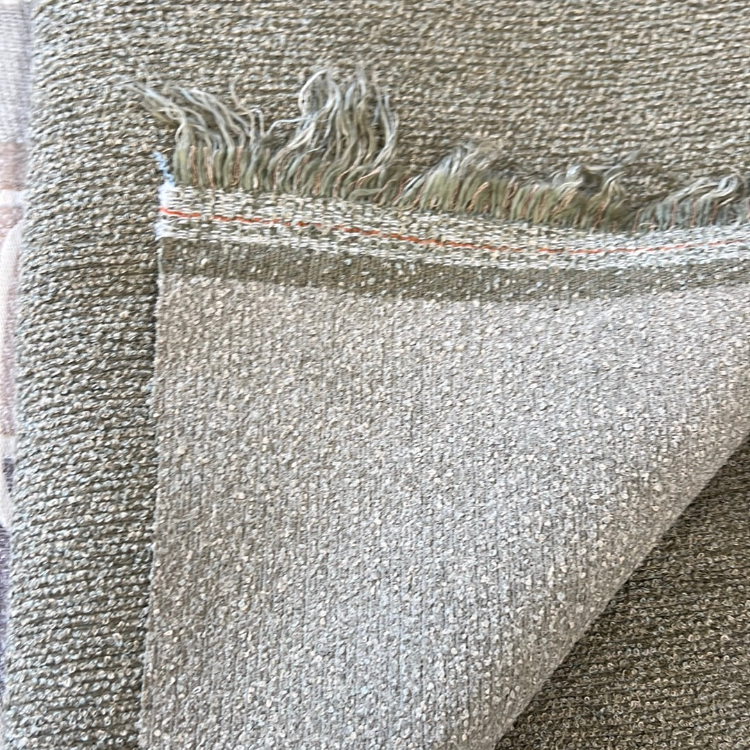 Textured gray fabric swatch with subtle fringe detail.