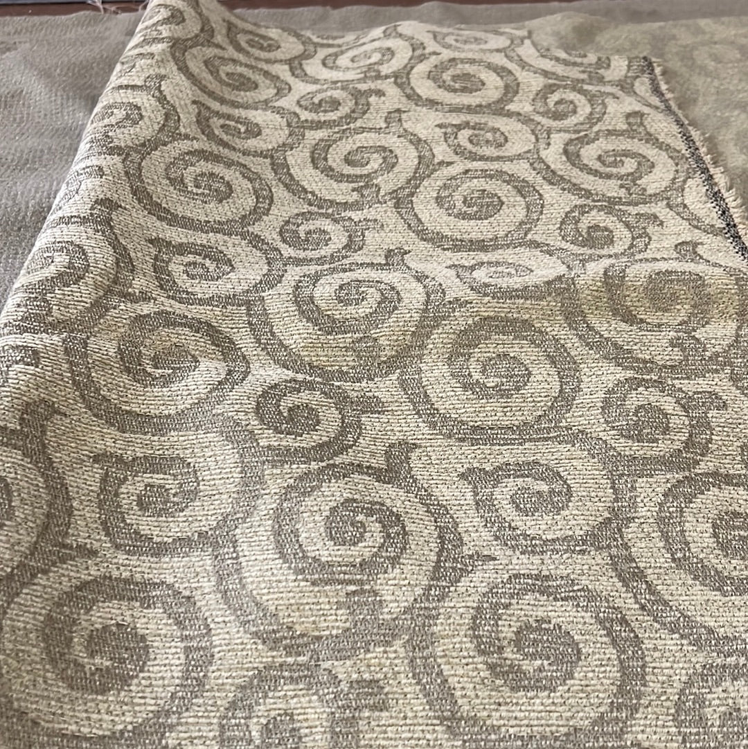 Beige fabric swatch with a textured swirl pattern.