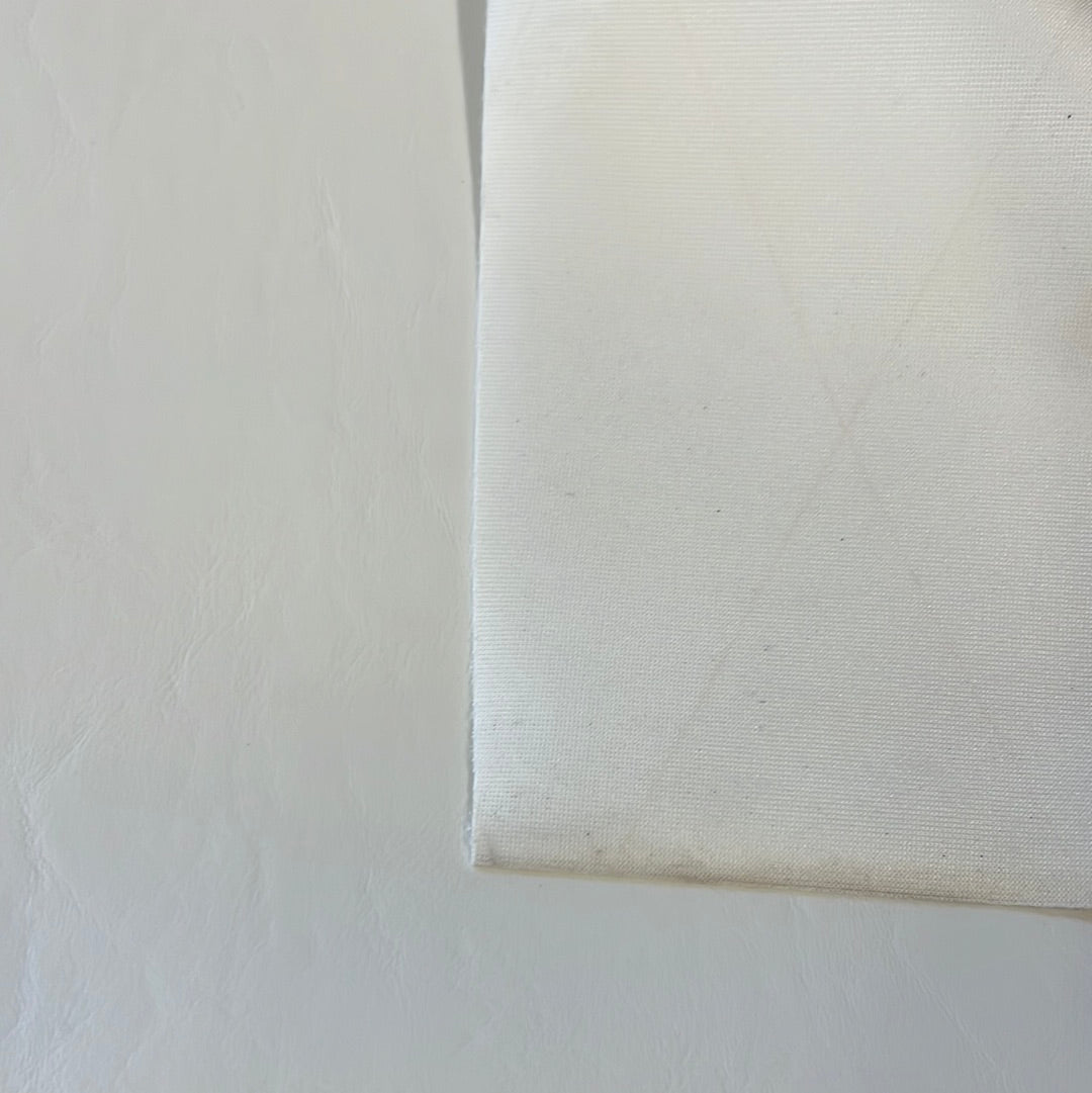 Off-white vinyl and fabric swatches side-by-side.