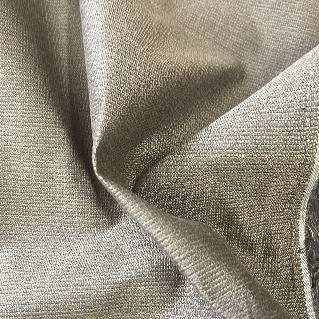 Close-up of textured fabric, showing subtle sheen and neutral tone.