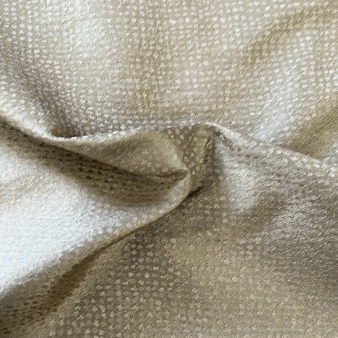 Draped sage-colored fabric with a subtle speckled pattern.
