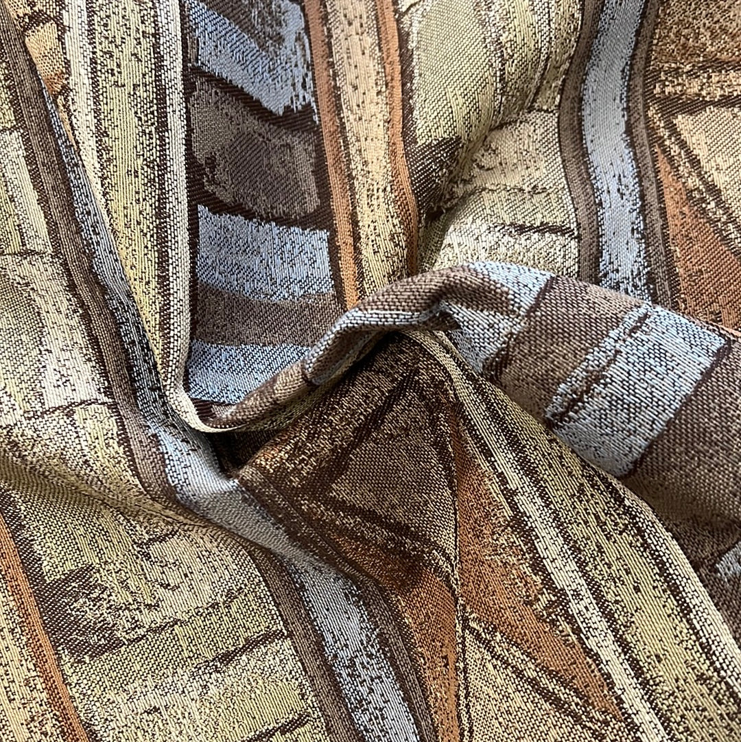 Brown, beige, and blue patterned upholstery fabric, detailed texture.