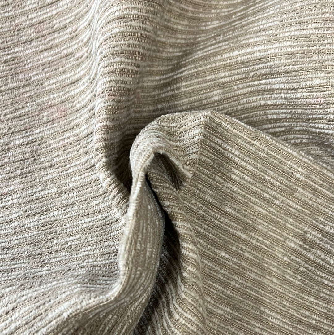 Beige ribbed fabric swatch, showing texture and drape.