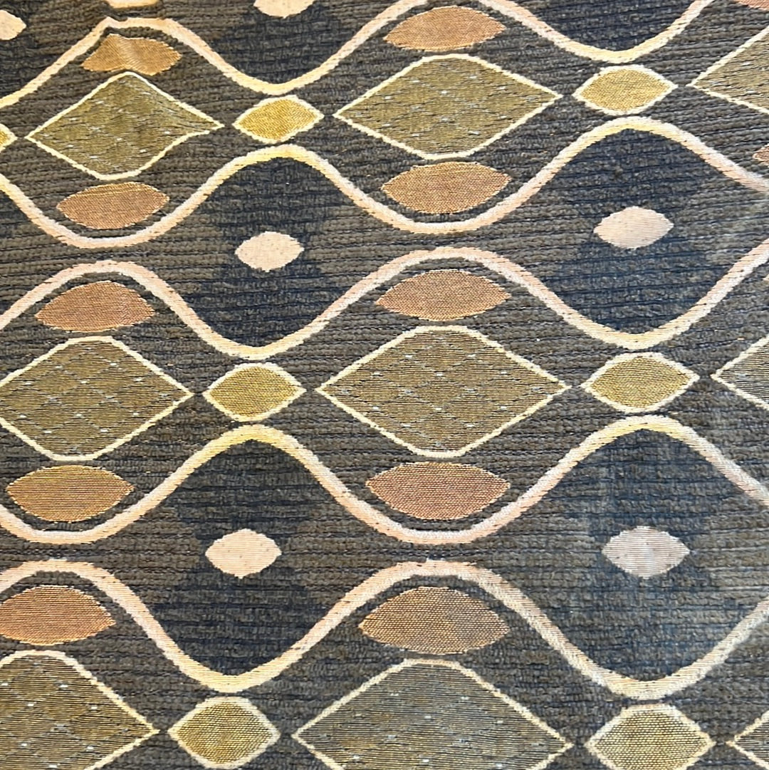 Brown fabric with gold and beige geometric pattern, ideal for upholstery or drapery.