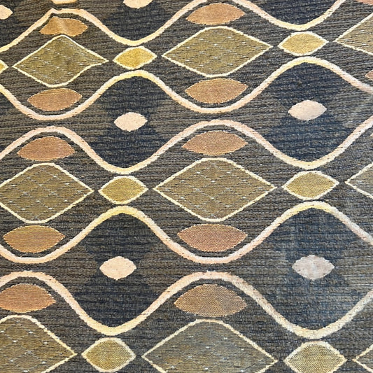 Brown fabric with gold and beige geometric pattern, ideal for upholstery or drapery.