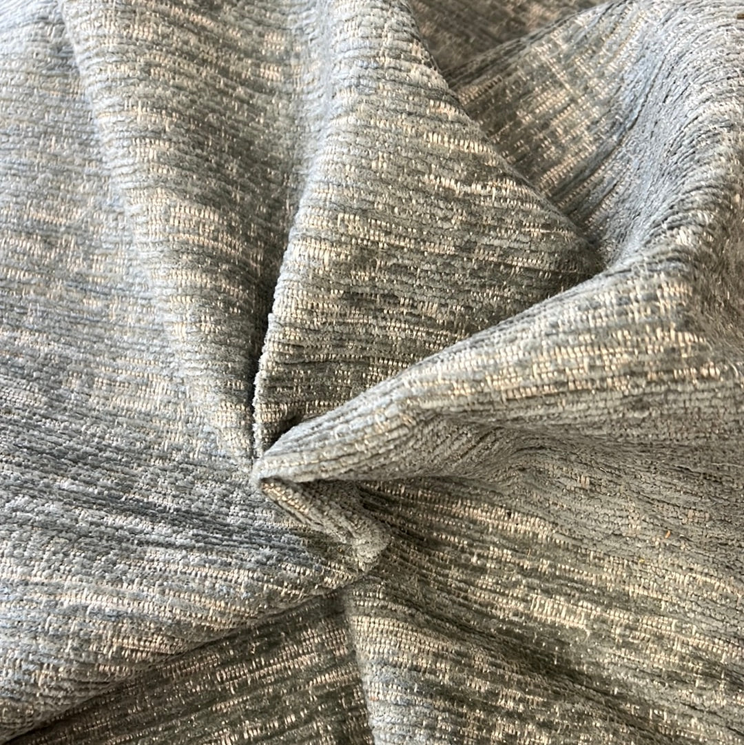 Textured sage-colored upholstery fabric swatch.