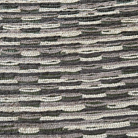 1920 Abracadabra Graphis fabric swatch: gray and beige textured upholstery material.