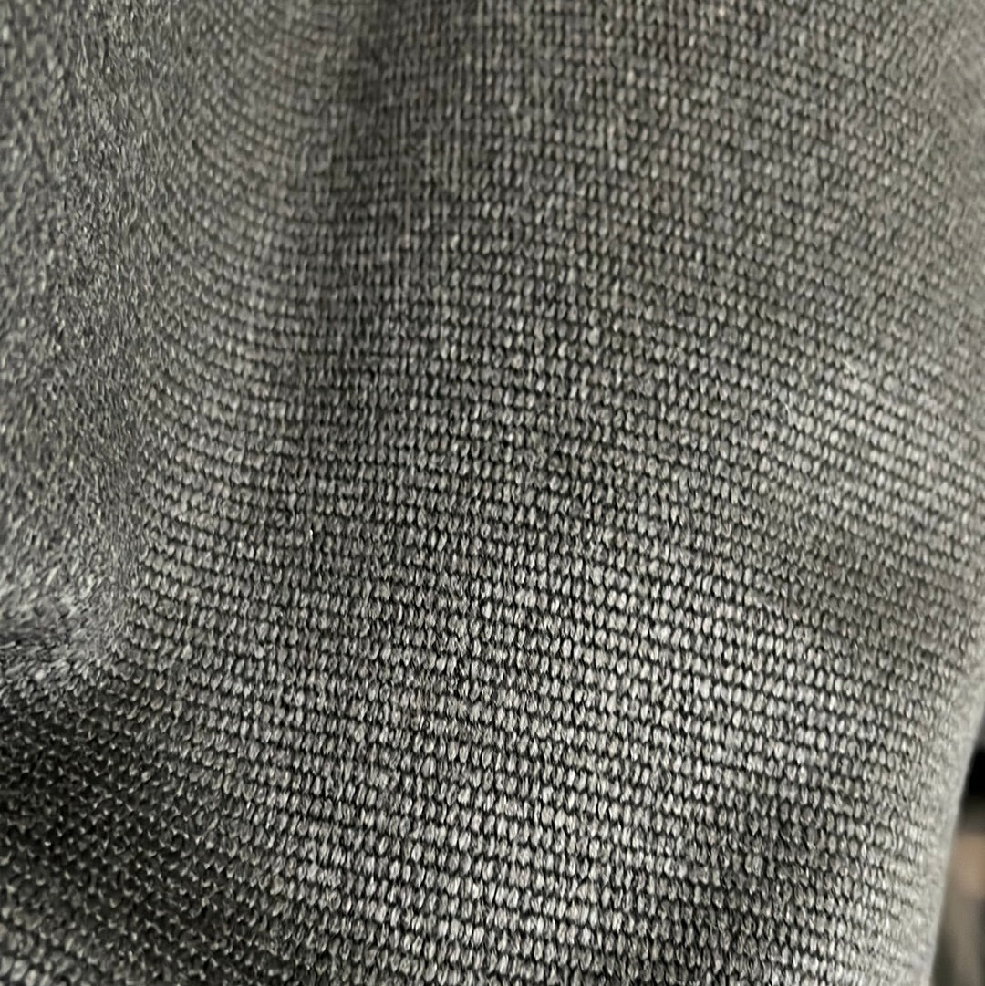 Close-up of dark gray fabric with a textured weave.