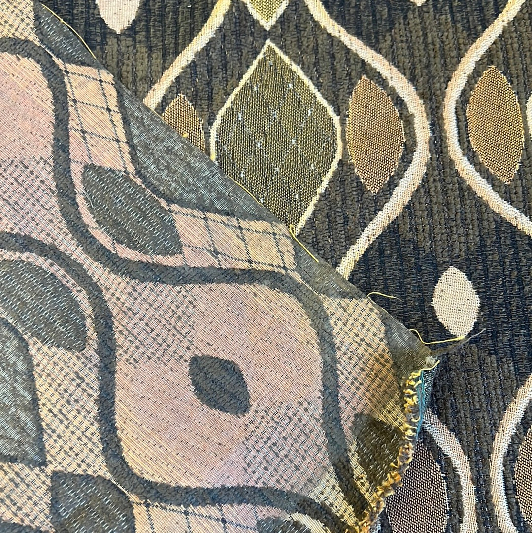 Close-up of brown patterned upholstery fabric samples showcasing geometric designs.