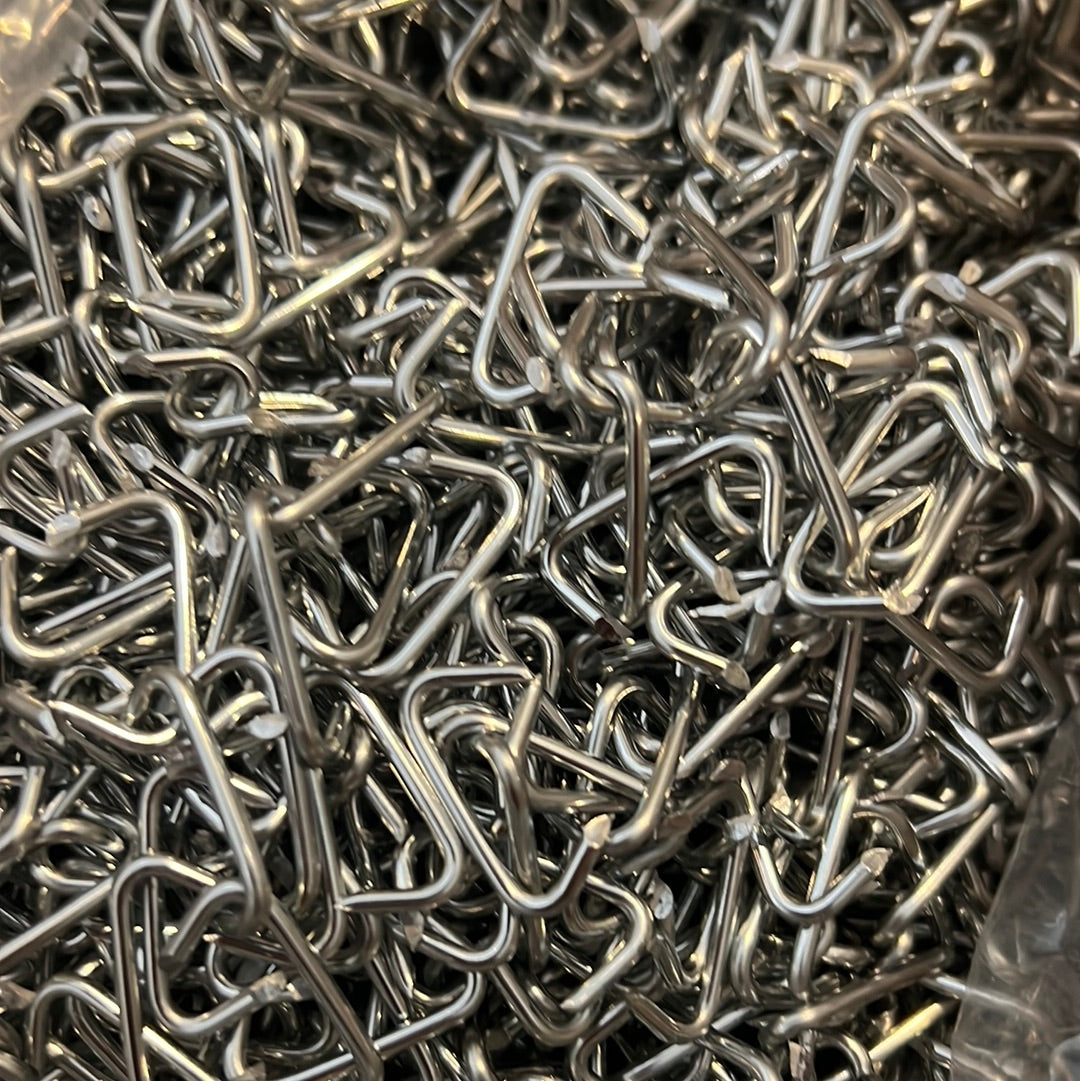 Five-pound bulk of silver metal hog rings.