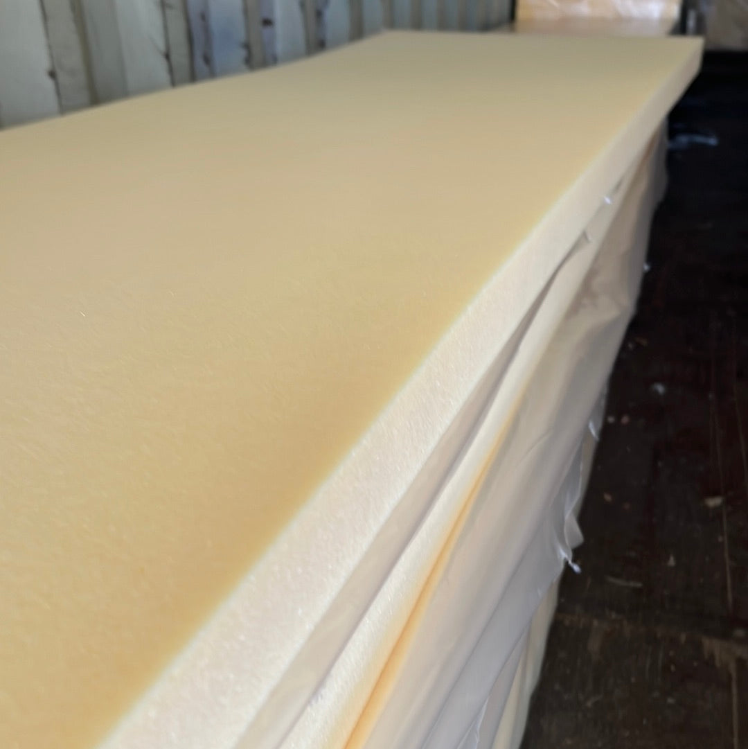 Cream-colored high-density foam sheets, stacked and wrapped, HR60 rating.