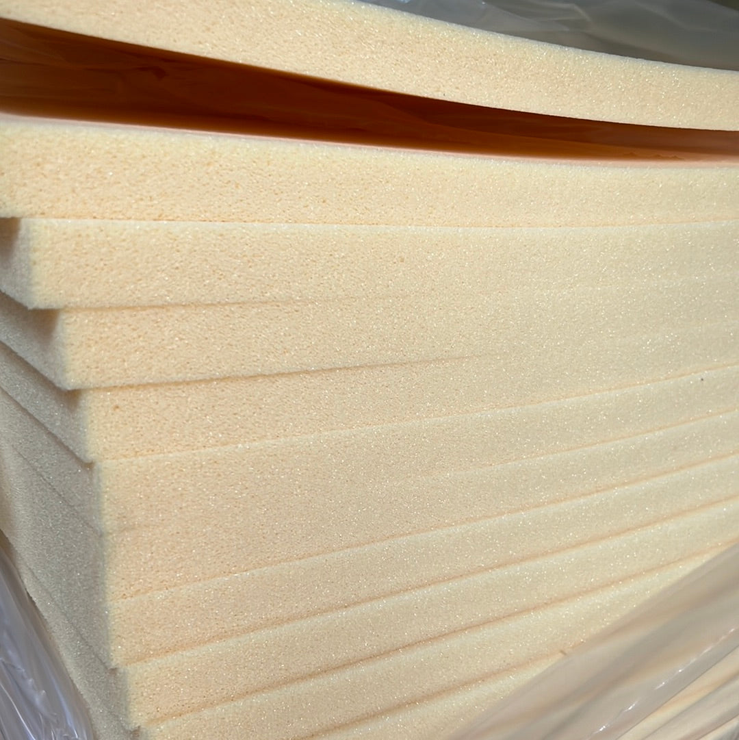 Stack of pale yellow extra-firm foam sheets, ideal for upholstery or crafting projects.