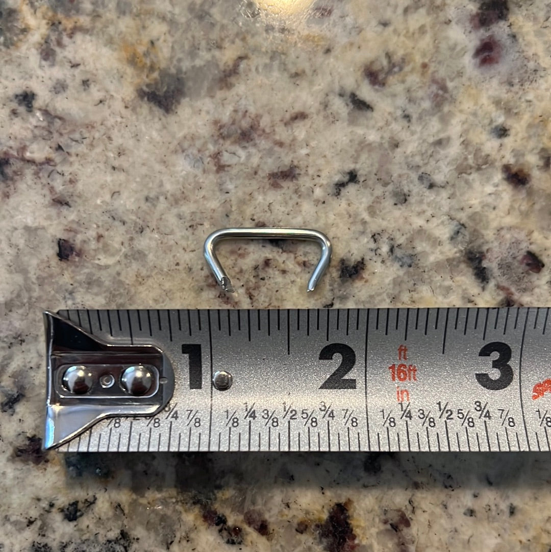 Silver hog ring next to ruler for size reference.