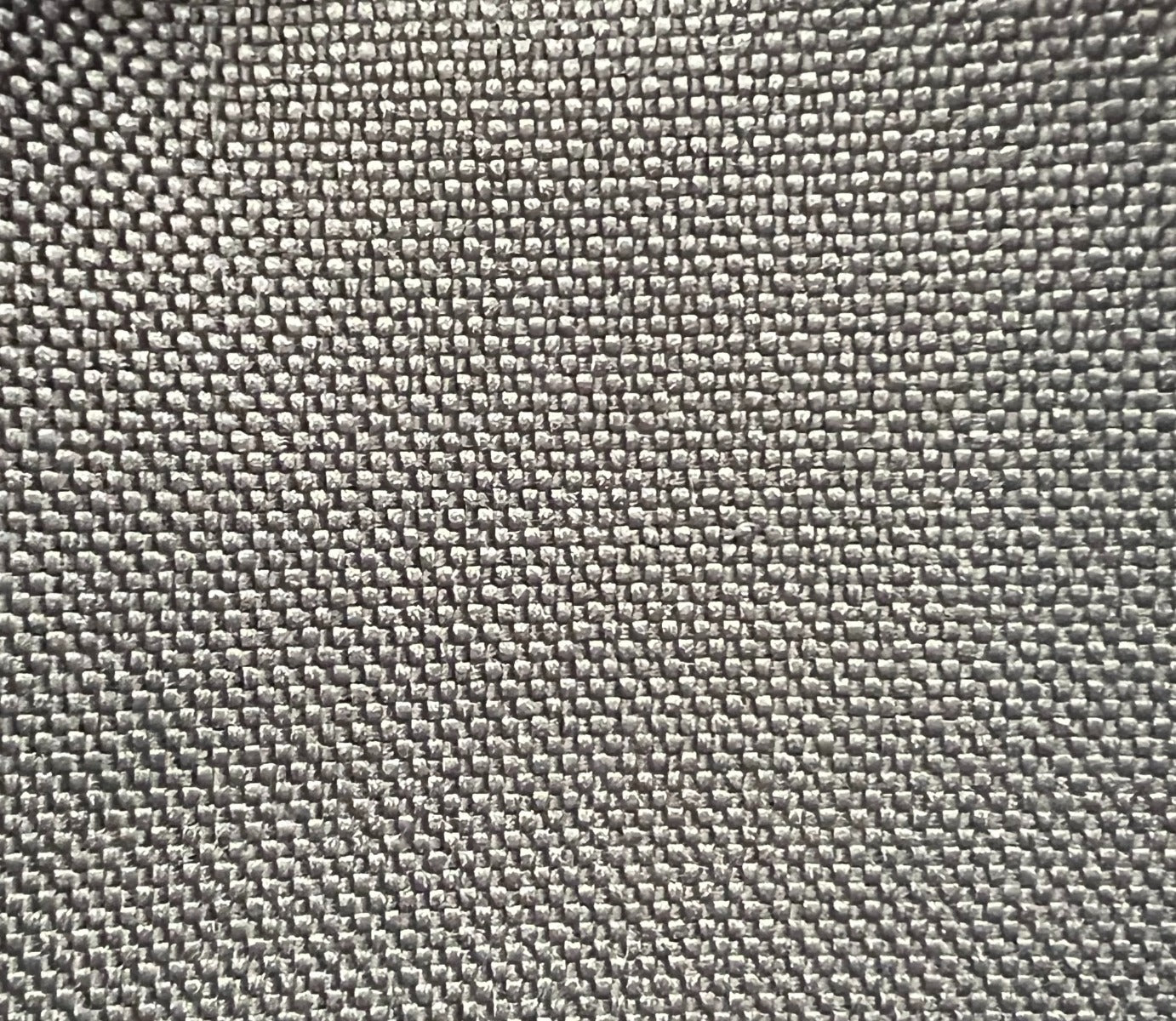 Close-up of New Canvas Onyx Ford fabric texture: dark gray, tightly woven canvas.