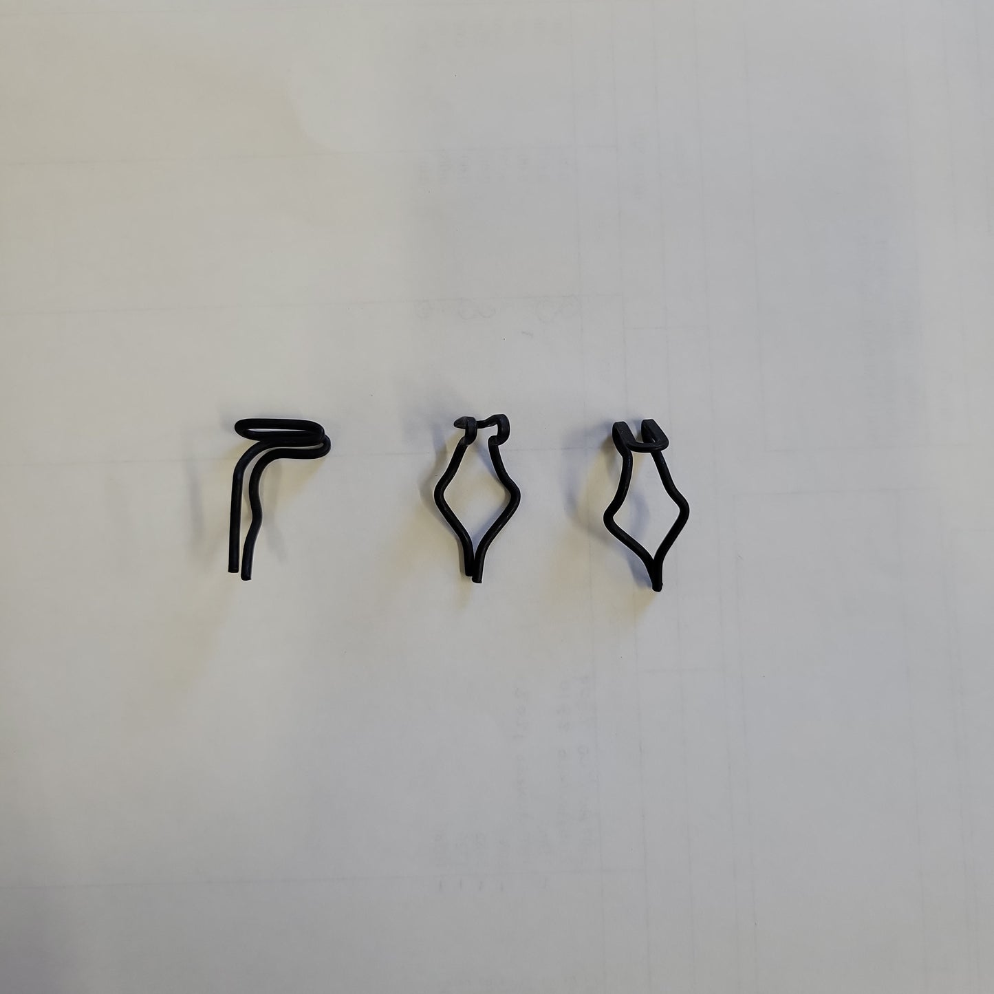 Black plastic retainers shown against a white background.