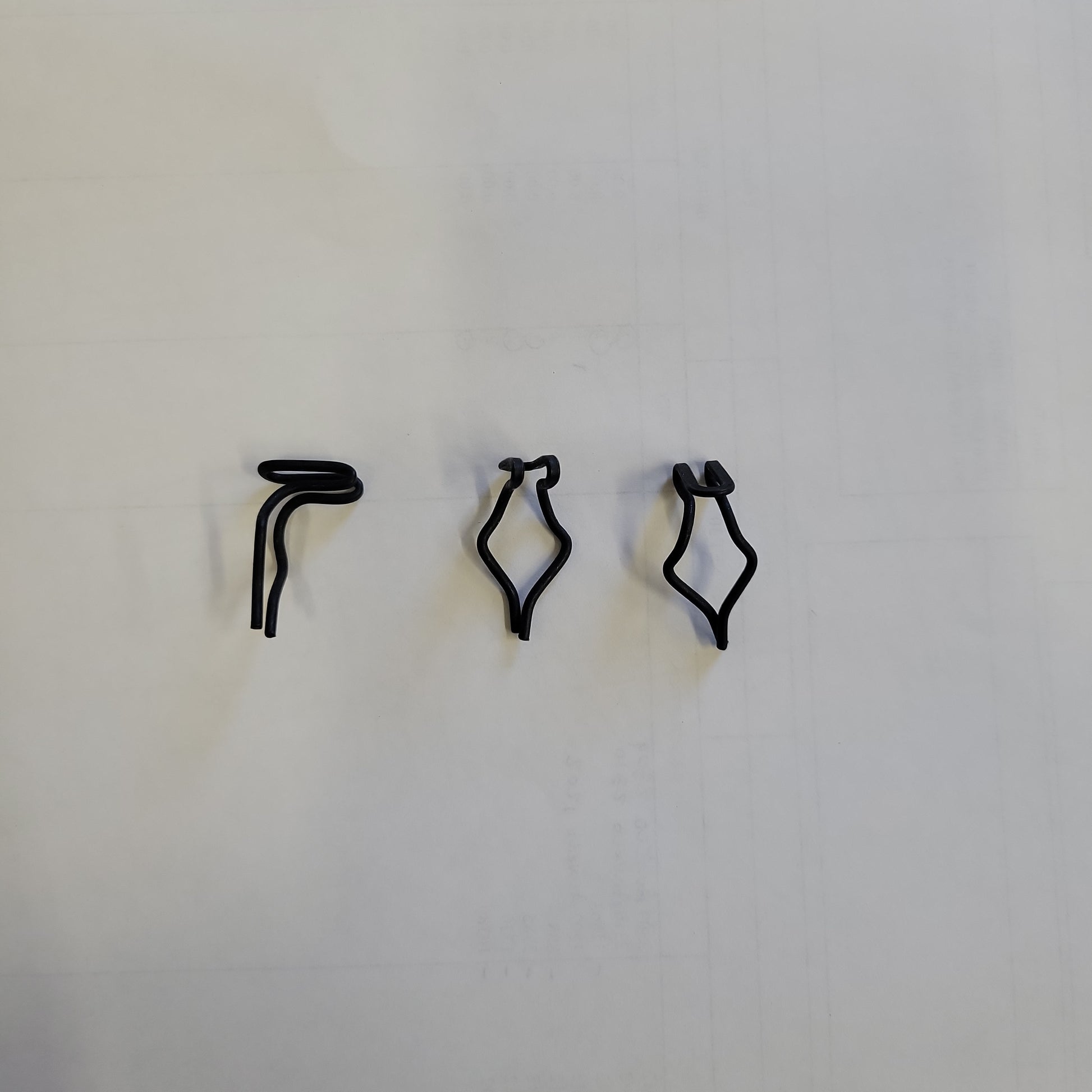 Black plastic retainers shown against a white background.